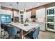 Modern kitchen boasts a large center island, stylish seating, and updated stainless steel appliances at 3310 Stonewyck St, Orlando, FL 32824
