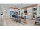 Bright, modern kitchen featuring a large center island with barstool seating and stainless-steel appliances at 3310 Stonewyck St, Orlando, FL 32824
