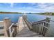 Scenic lake view from a wooden dock and staircase featuring a fountain and waterfront homes at 3310 Stonewyck St, Orlando, FL 32824