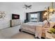 Comfortable main bedroom featuring TV, accent wall, ceiling fan, and exterior view at 3310 Stonewyck St, Orlando, FL 32824