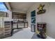 Outdoor kitchen with stainless steel appliances, cooler and a decorative privacy screen at 3310 Stonewyck St, Orlando, FL 32824