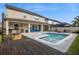Outdoor living with a pool, firepit, built-in grill, and covered patio seating for year-round entertaining at 3310 Stonewyck St, Orlando, FL 32824