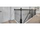 Upstairs staircase landing with decorative wrought iron railing and neutral carpeting at 3310 Stonewyck St, Orlando, FL 32824