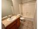 Standard bathroom featuring a single sink vanity, toilet, and shower-tub combination at 404 S Salisbury Ave, Deland, FL 32720
