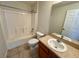 Bathroom featuring a shower-tub combo, tile flooring, modern sink, and vanity with a large mirror at 404 S Salisbury Ave, Deland, FL 32720