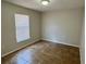 Simple bedroom with tile floors, neutral paint, and a bright window offering ample natural light at 404 S Salisbury Ave, Deland, FL 32720
