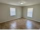 Clean bedroom with tile floors, neutral paint, and two windows providing lots of natural light at 404 S Salisbury Ave, Deland, FL 32720