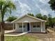 Charming single-story home featuring a covered front porch and a well-maintained lawn with fresh landscaping at 404 S Salisbury Ave, Deland, FL 32720
