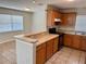 Well-lit kitchen featuring wooden cabinetry, granite countertops, tiled floors and modern appliances at 404 S Salisbury Ave, Deland, FL 32720