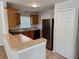 Functional kitchen with stainless steel refrigerator, matching cabinets, and breakfast bar with granite countertops at 404 S Salisbury Ave, Deland, FL 32720