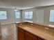 Open living area with a ceiling fan, tile flooring, plenty of natural light, and access to the kitchen at 404 S Salisbury Ave, Deland, FL 32720