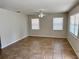 Bright living room with tile floors, neutral walls, and ample natural light from multiple windows at 404 S Salisbury Ave, Deland, FL 32720