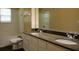 Bathroom with double sink vanity, granite countertop and tub with shower at 413 Summit Ridge Pl # 215, Longwood, FL 32779