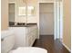Well lit bathroom boasts a double vanity, wood-look tile flooring, and closet access at 413 Summit Ridge Pl # 215, Longwood, FL 32779