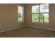 Neutral bedroom features natural light from two windows and a neutral carpet at 413 Summit Ridge Pl # 215, Longwood, FL 32779