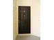 Solid black front door featuring a peephole, door knocker, and the unit number '215' at 413 Summit Ridge Pl # 215, Longwood, FL 32779
