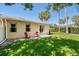 Well-maintained backyard with lush green lawn, patio, sliding glass door, and palm trees at 432 Harbor Winds Ct, Winter Springs, FL 32708