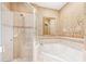 Relaxing bathroom with separate shower and tub, tile surround, and stylish neutral color palette at 432 Harbor Winds Ct, Winter Springs, FL 32708