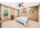Cozy bedroom with neutral carpet, a ceiling fan, two windows, and unique textured walls at 432 Harbor Winds Ct, Winter Springs, FL 32708