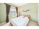Cozy bedroom with plush carpet, natural light, and a soothing, muted color scheme at 432 Harbor Winds Ct, Winter Springs, FL 32708