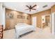 Comfortable bedroom showcasing carpeted floors, unique textured walls, and an ensuite bathroom at 432 Harbor Winds Ct, Winter Springs, FL 32708