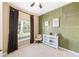 Cozy bedroom with decorative wallpaper accent wall, window with blinds, and white shelving unit at 432 Harbor Winds Ct, Winter Springs, FL 32708
