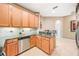 Well-lit kitchen with granite countertops, stainless steel dishwasher, and ample wood cabinetry at 432 Harbor Winds Ct, Winter Springs, FL 32708