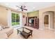 Comfortable living room showcasing tile floors, a ceiling fan, and sliding glass doors to the backyard at 432 Harbor Winds Ct, Winter Springs, FL 32708