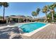 Community pool area with palm trees, ample seating, and a covered lounge area for residents at 432 Harbor Winds Ct, Winter Springs, FL 32708