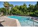 Well-kept community pool surrounded by lush greenery, sun loungers, and a secure fence at 432 Harbor Winds Ct, Winter Springs, FL 32708