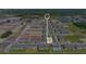 Aerial view with locator symbol indicating a residential area with new townhomes, green spaces, and community amenities at 4353 Campsite Loop, Orlando, FL 32824
