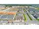 Aerial view showcases a community with new townhomes, manicured lawns, and a combination of completed and under-construction buildings at 4353 Campsite Loop, Orlando, FL 32824