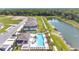 Community aerial view showcases the pool, landscaping, and walking path by the lake at 4353 Campsite Loop, Orlando, FL 32824