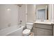 Well-lit bathroom with a tiled shower-tub, a white toilet, and a modern single-sink vanity at 4353 Campsite Loop, Orlando, FL 32824