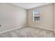 Comfortable bedroom showcases neutral decor, plush carpeting, and a bright window for natural light at 4353 Campsite Loop, Orlando, FL 32824