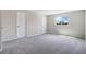 Comfortable bedroom offers a peaceful haven with soft carpet, neutral walls, and natural light at 4353 Campsite Loop, Orlando, FL 32824