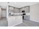 Well-equipped kitchen with stainless steel appliances, gray cabinetry, and a functional island for food prep at 4353 Campsite Loop, Orlando, FL 32824