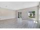 Spacious living room boasting sleek wood floors, recessed lighting, and large windows offering ample natural light at 4353 Campsite Loop, Orlando, FL 32824