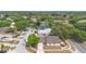 Aerial view of a home situated in a lush neighborhood close to a school with blue roofing at 4636 Fern Pine Dr, Orlando, FL 32808