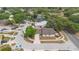 Aerial view of a home situated in a lush neighborhood close to a school with blue roofing at 4636 Fern Pine Dr, Orlando, FL 32808