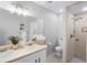 Bright bathroom featuring a dual sink vanity, walk-in shower with neutral tile, and mosaic tile flooring at 4636 Fern Pine Dr, Orlando, FL 32808