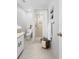 Well-lit bathroom with a walk-in shower featuring neutral tiling, mosaic tile flooring, and a single sink vanity at 4636 Fern Pine Dr, Orlando, FL 32808