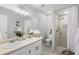 Bright bathroom featuring a dual sink vanity, walk-in shower with neutral tile, and mosaic tile flooring at 4636 Fern Pine Dr, Orlando, FL 32808