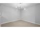 Dining room with modern light fixture and neutral walls at 4636 Fern Pine Dr, Orlando, FL 32808