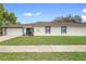 Charming single-story home featuring a well-maintained lawn, two car garage, and neutral color scheme at 4636 Fern Pine Dr, Orlando, FL 32808