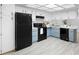 Stylish kitchen features white and blue cabinets, modern appliances, and ample counter space, creating an inviting culinary haven at 4636 Fern Pine Dr, Orlando, FL 32808