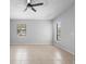 Neutral living room with tile floor and great natural light from two windows and ceiling fan at 4636 Fern Pine Dr, Orlando, FL 32808