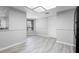 Neutral living room featuring gray flooring, baseboards, and natural light at 4636 Fern Pine Dr, Orlando, FL 32808