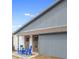Exterior of home with patio seating set with blue cushions and flowers, perfect for outdoor relaxation at 4636 Fern Pine Dr, Orlando, FL 32808