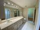 Bathroom featuring double sinks, vanity with drawers, and tile flooring at 5050 Hidden Springs Blvd, Orlando, FL 32819